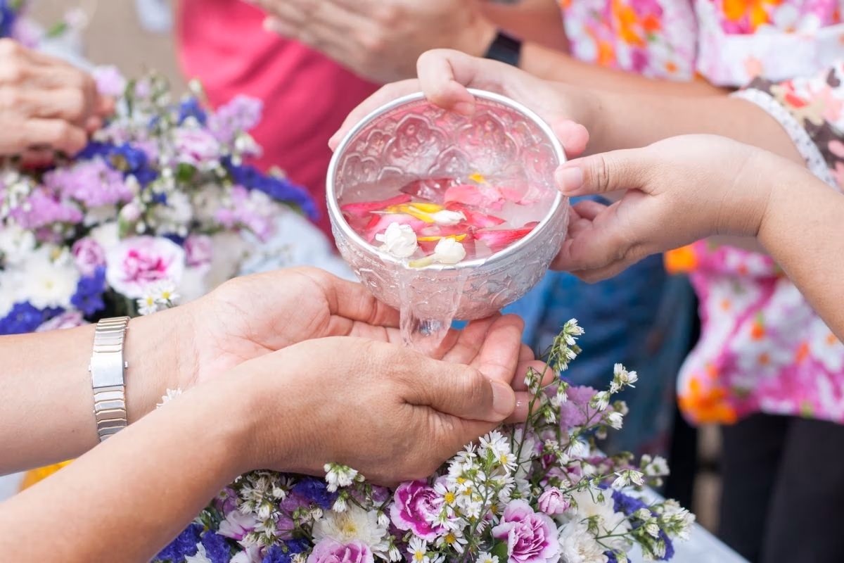 Traditional Rod Nam Dam Hua ceremony with scented water in Thailand