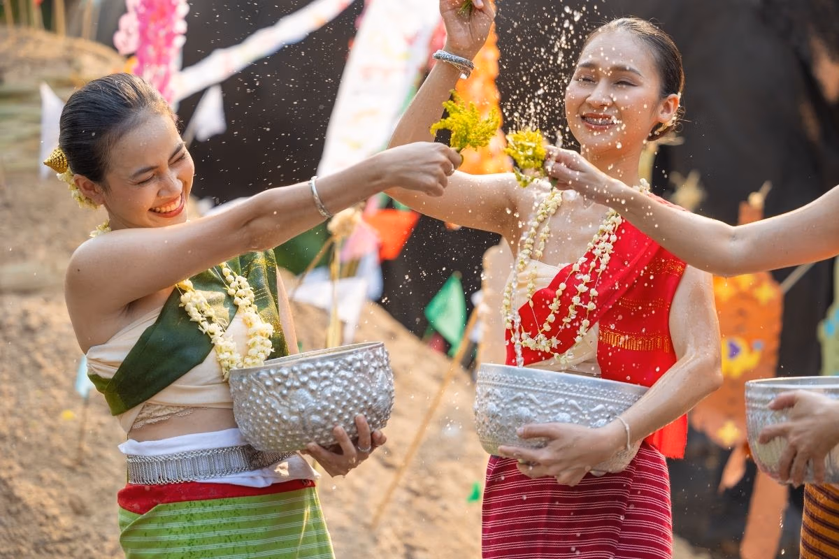 People celebrating Songkran by splashing water during the Thai New Year festival